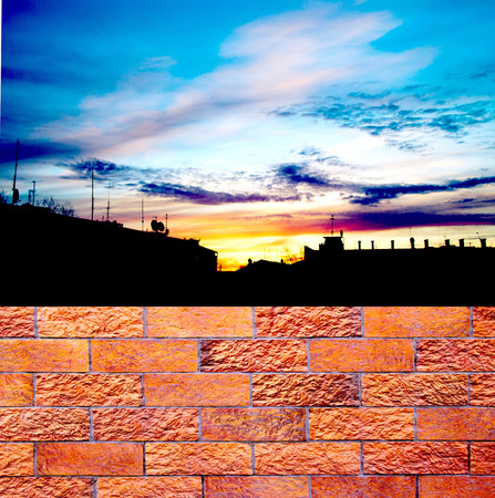 fence of decorative red brick wall against blue sky