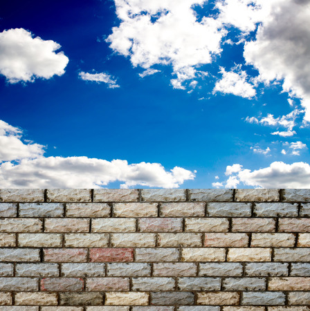 decorative  brick fence wall against blue skyの写真素材