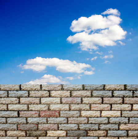 decorative  brick fence wall against blue skyの写真素材