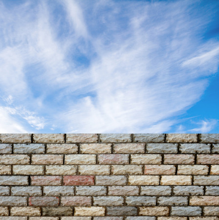 decorative  brick fence wall against blue skyの写真素材