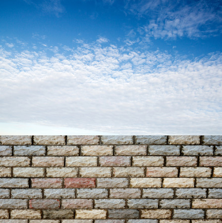 decorative  brick fence wall against blue skyの写真素材