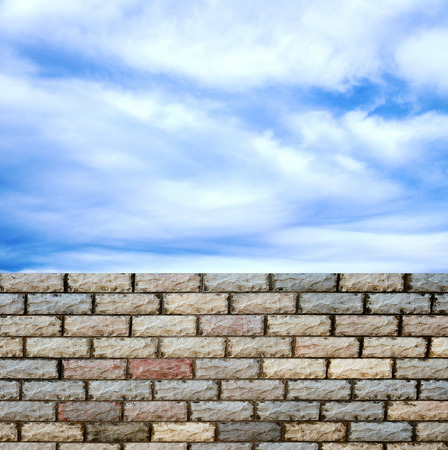 decorative  brick fence wall against blue skyの写真素材