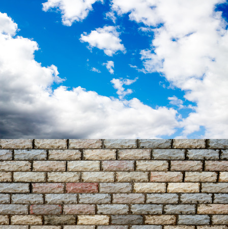 decorative  brick fence wall against blue skyの写真素材