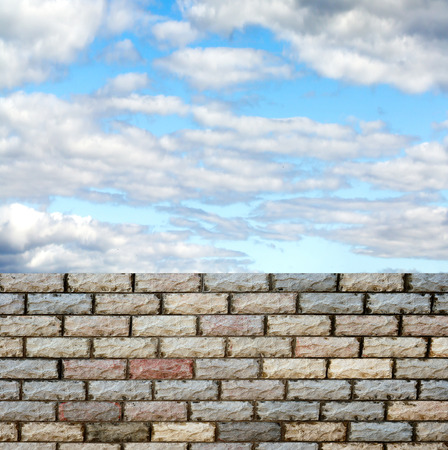 decorative  brick fence wall against blue skyの写真素材