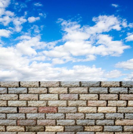 decorative  brick fence wall against blue skyの写真素材