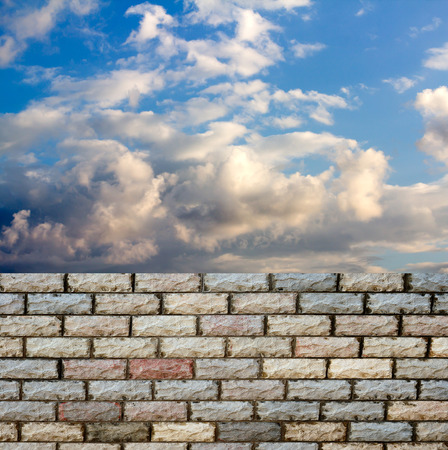 decorative  brick fence wall against blue skyの写真素材