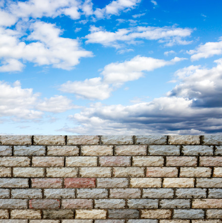 decorative  brick fence wall against blue skyの写真素材