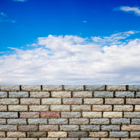 decorative  brick fence wall against blue skyの写真素材