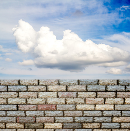 decorative  brick fence wall against blue skyの写真素材