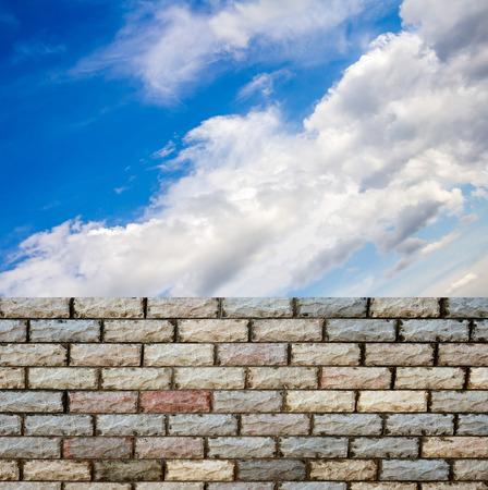 decorative  brick fence wall against blue skyの写真素材