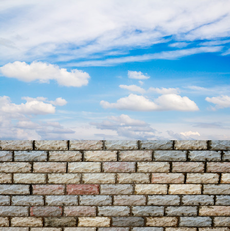 decorative  brick fence wall against blue skyの写真素材