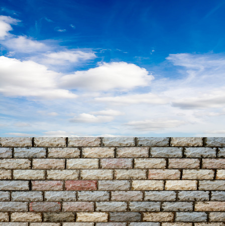 decorative  brick fence wall against blue skyの写真素材