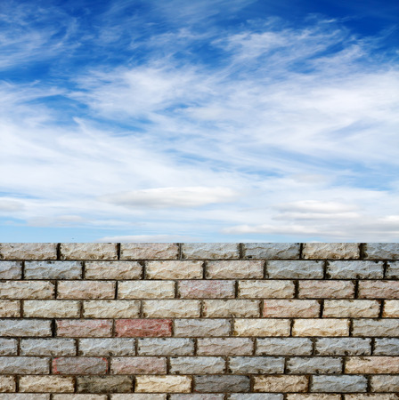 decorative  brick fence wall against blue skyの写真素材