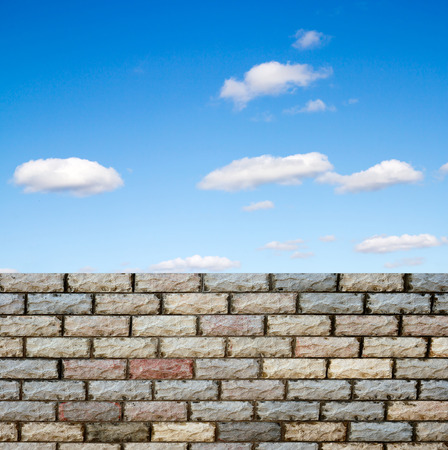 decorative  brick fence wall against blue skyの写真素材