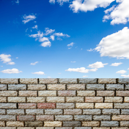 decorative  brick fence wall against blue skyの写真素材