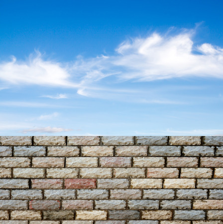 decorative  brick fence wall against blue skyの写真素材