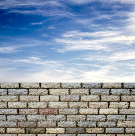 decorative  brick fence wall against blue skyの写真素材
