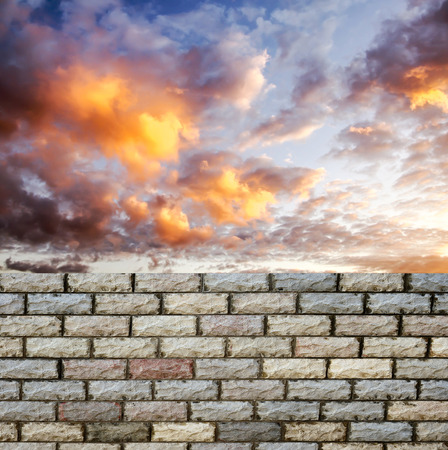 decorative  brick fence wall against blue skyの写真素材