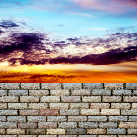 decorative  brick fence wall against blue skyの写真素材