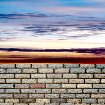 decorative  brick fence wall against blue skyの写真素材