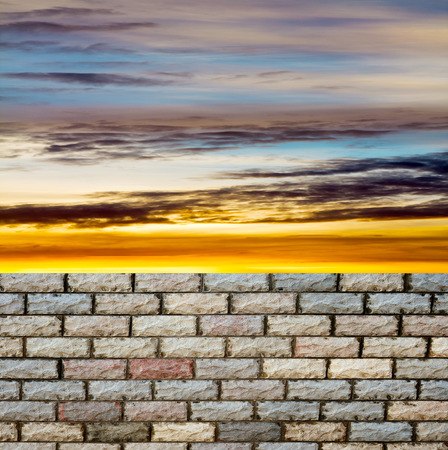 decorative  brick fence wall against blue skyの写真素材
