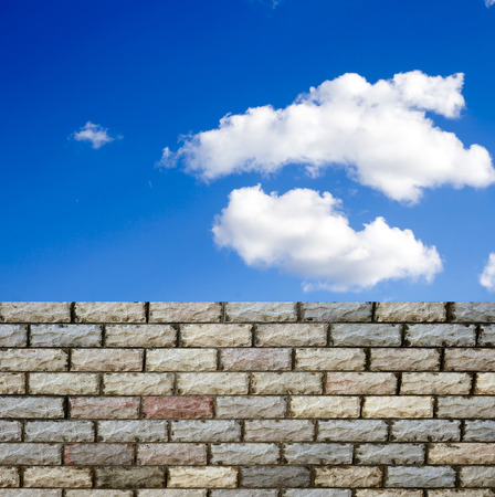 decorative  brick fence wall against blue skyの写真素材