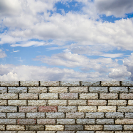 decorative  brick fence wall against blue skyの写真素材