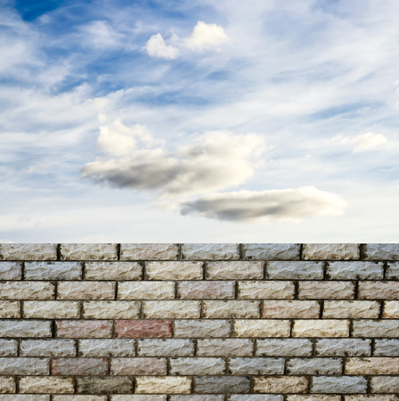 decorative  brick fence wall against blue skyの写真素材
