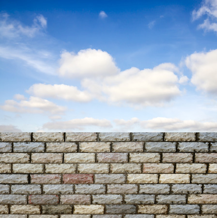 decorative  brick fence wall against blue skyの写真素材