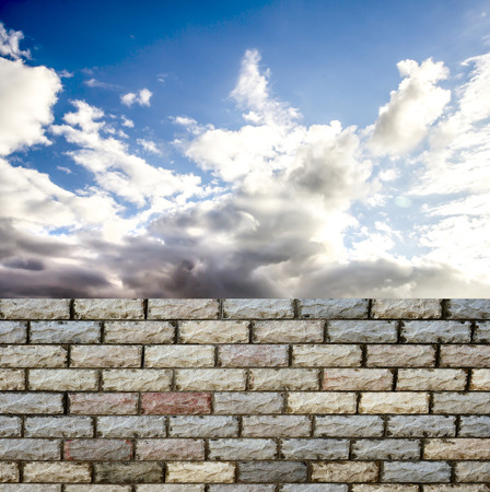 decorative  brick fence wall against blue skyの写真素材