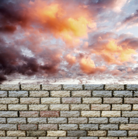 decorative  brick fence wall against blue skyの写真素材
