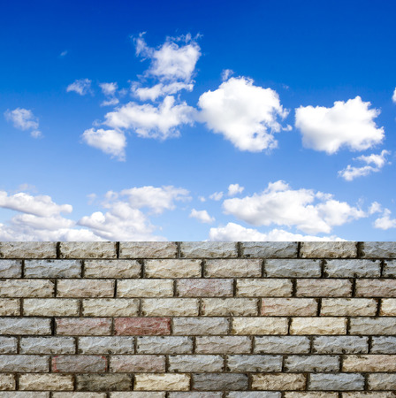 decorative  brick fence wall against blue skyの写真素材