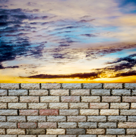 decorative  brick fence wall against blue skyの写真素材