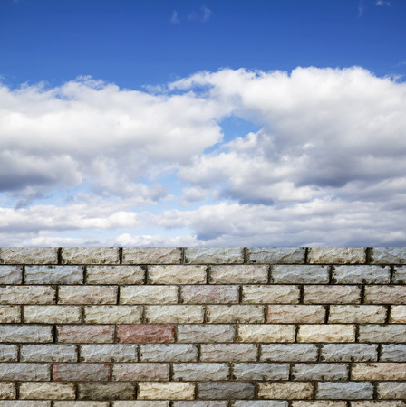 decorative  brick fence wall against blue skyの写真素材