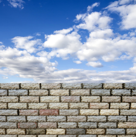 decorative  brick fence wall against blue skyの写真素材