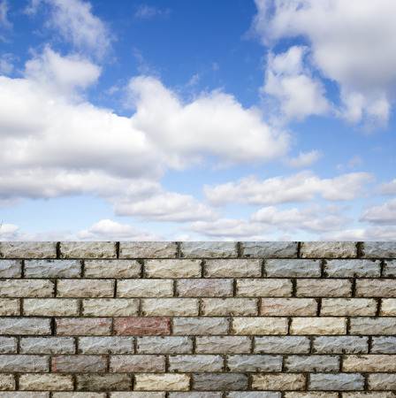 decorative  brick fence wall against blue skyの写真素材