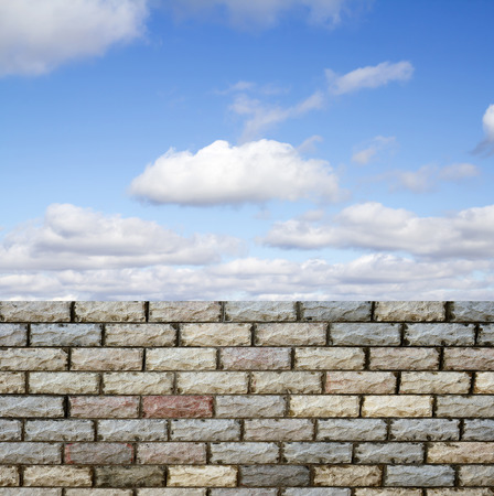 decorative  brick fence wall against blue skyの写真素材