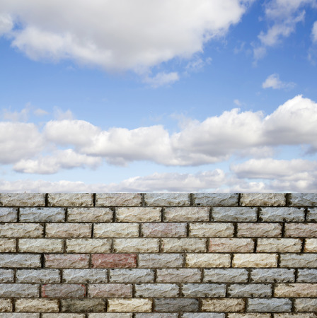 decorative  brick fence wall against blue skyの写真素材