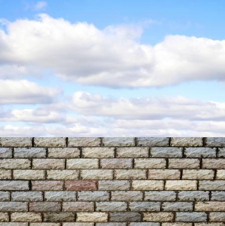 decorative  brick fence wall against blue skyの写真素材