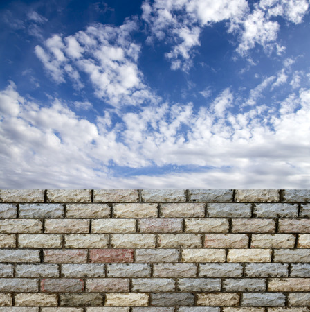 decorative  brick fence wall against blue skyの写真素材