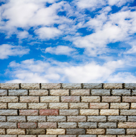 decorative  brick fence wall against blue skyの写真素材