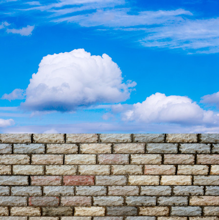 decorative  brick fence wall against blue skyの写真素材