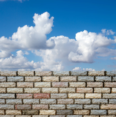 decorative  brick fence wall against blue skyの写真素材