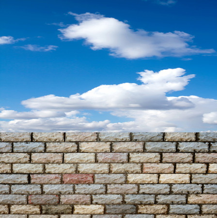 decorative  brick fence wall against blue skyの写真素材