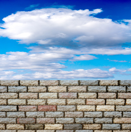 decorative  brick fence wall against blue skyの写真素材