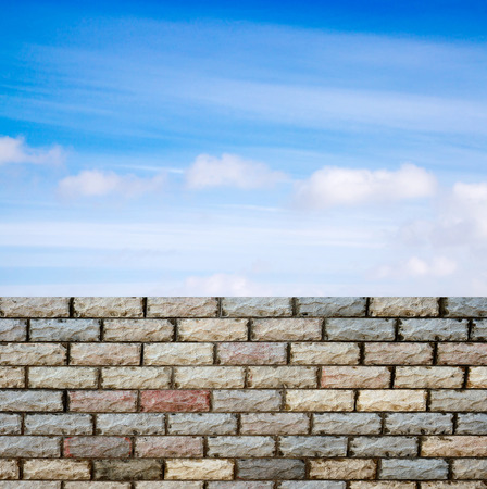 decorative  brick fence wall against blue skyの写真素材