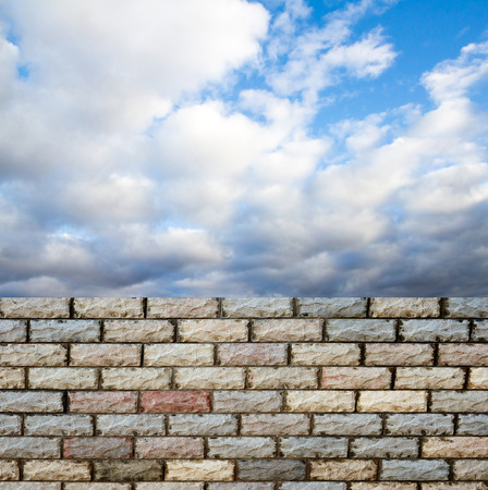 decorative  brick fence wall against blue skyの写真素材