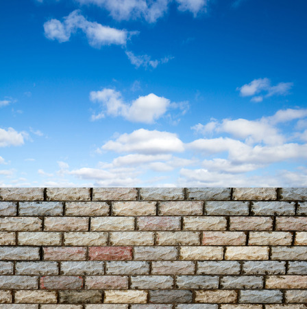 decorative  brick fence wall against blue skyの写真素材