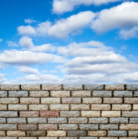decorative  brick fence wall against blue skyの写真素材