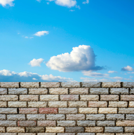 decorative  brick fence wall against blue skyの写真素材